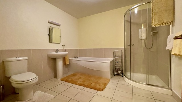 Apartment bathroom with bath and separate shower