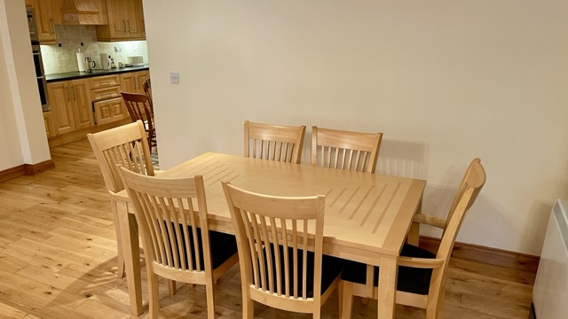 Dining table beside kitchen entrance