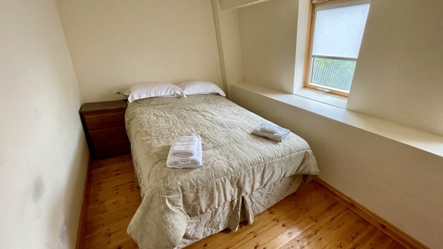 Double bedroom with towels laid out on the bed