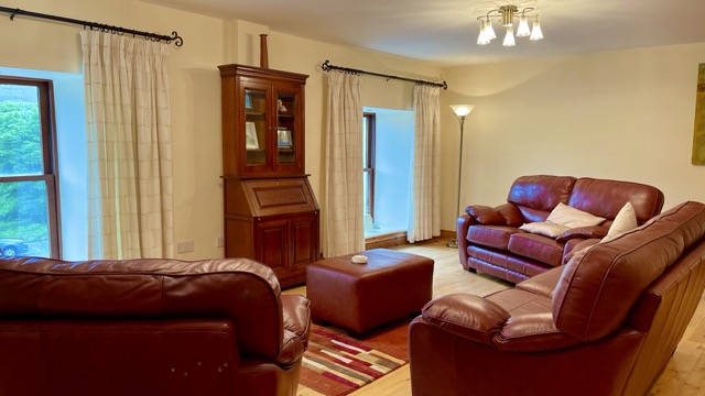 Comfortable sitting room with red leather sofas