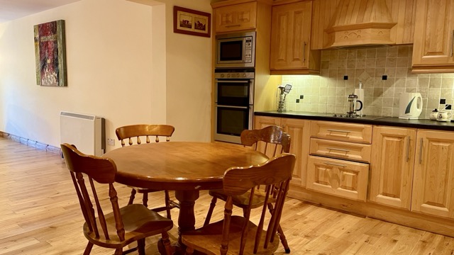 Warm wooden kitchen with dining table
