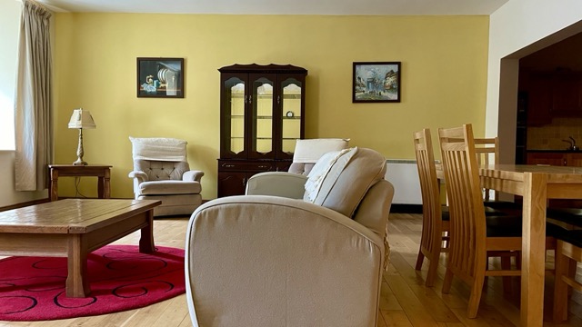 Bright lounge with cream seating and dining area