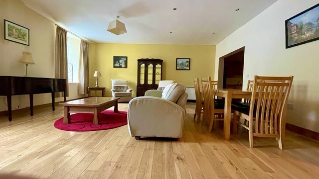 Wide open living and dining room with wooden floor
