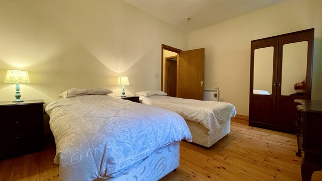 Twin bedroom with two beds and wooden furniture