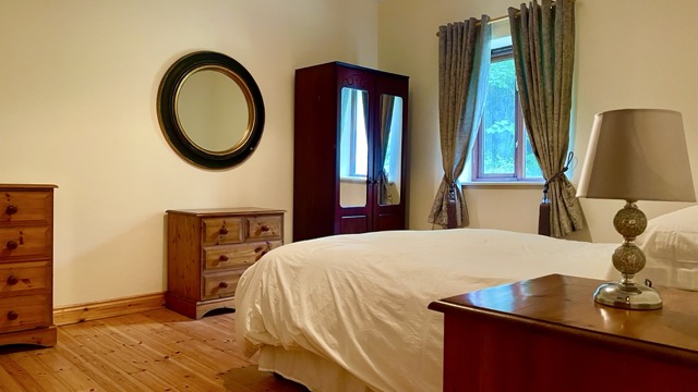 Double bedroom with wardrobe, lamp and window