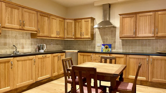 Large fitted kitchen with central dining table