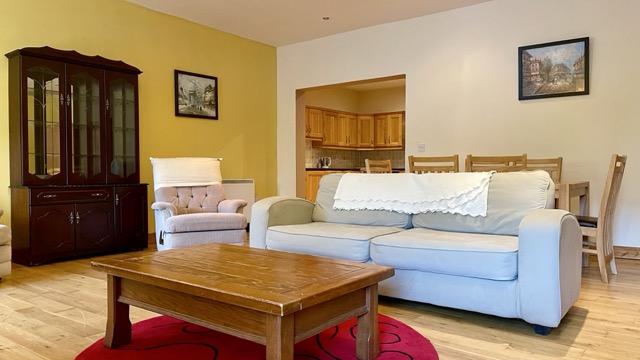 Bright lounge with cream sofa and display cabinet