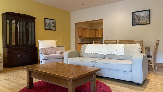 Cream sofa lounge with kitchen and dining area behind