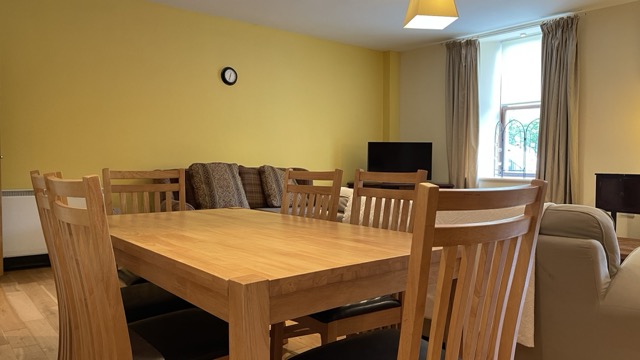 Dining table in foreground with living area behind