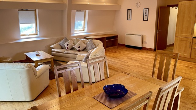 Open-plan apartment lounge and dining space