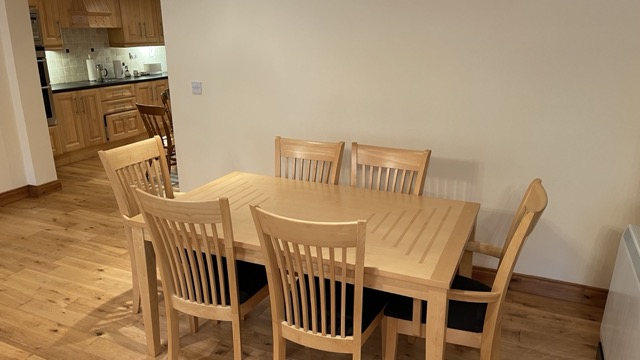 Simple dining area with wooden table and chairs