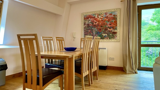 Dining table beside a window with green views